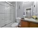 Bathroom with tub shower combo, wood vanity, and flowers at 2758 Sun Key Pl, Kissimmee, FL 34747