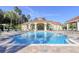 Resort-style pool with lounge chairs and a clubhouse in the background at 2758 Sun Key Pl, Kissimmee, FL 34747