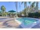 Relaxing hot tub area with lounge chairs and palm trees at 2758 Sun Key Pl, Kissimmee, FL 34747