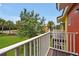 View from balcony overlooking grassy area with trees and homes at 2758 Sun Key Pl, Kissimmee, FL 34747