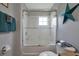 Clean bathroom with a tub and shower, and white tile at 2758 Sun Key Pl, Kissimmee, FL 34747
