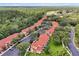 Aerial view of community featuring multiple buildings, lush landscaping, and ample parking at 2758 Sun Key Pl, Kissimmee, FL 34747