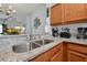 Modern kitchen sink with granite countertops and wood cabinets at 2758 Sun Key Pl, Kissimmee, FL 34747