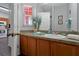 Clean bathroom with wood vanity and a large mirror at 2758 Sun Key Pl, Kissimmee, FL 34747
