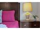 Dark brown nightstand with lamp and small plant at 2758 Sun Key Pl, Kissimmee, FL 34747