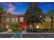 Two story townhome at dusk with landscaping at 2758 Sun Key Pl, Kissimmee, FL 34747