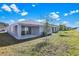 View of home's back and backyard at 4063 Bannock Ave, Tavares, FL 32778