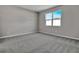 Bright bedroom with grey carpet and large window at 4063 Bannock Ave, Tavares, FL 32778