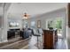 Spacious living room with comfortable seating, a large TV and access to a balcony at 7714 Excitement Dr, Reunion, FL 34747