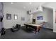 Game room features a pool table, gaming consoles, and comfortable seating at 7714 Excitement Dr, Reunion, FL 34747