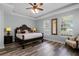 Spacious main bedroom with a king-size bed, ample natural light, and a sitting area at 7714 Excitement Dr, Reunion, FL 34747