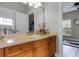 Bathroom boasts a vanity with wood cabinets and a large mirror at 7714 Excitement Dr, Reunion, FL 34747
