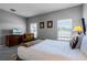 Bedroom with a queen bed, a comfortable armchair, and large windows at 7714 Excitement Dr, Reunion, FL 34747