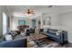 Elegant living room with leather sofas, a coffee table, and a wood bar at 7714 Excitement Dr, Reunion, FL 34747