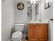 Convenient powder room with wood vanity and granite countertop at 7714 Excitement Dr, Reunion, FL 34747