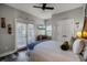 Bedroom with a queen bed, beach theme, and access to a balcony at 7714 Excitement Dr, Reunion, FL 34747