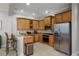 Well-equipped kitchen featuring wood cabinets, granite countertops, and stainless steel appliances at 7714 Excitement Dr, Reunion, FL 34747