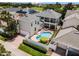 Aerial view of house with pool and solar panels at 7714 Excitement Dr, Reunion, FL 34747