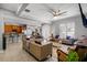Open concept living area with comfortable seating, large windows, and views of the backyard at 7714 Excitement Dr, Reunion, FL 34747