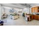 Open floor plan with kitchen featuring wood cabinets, granite counters, and stainless steel appliances; adjacent living room with comfortable seating at 7714 Excitement Dr, Reunion, FL 34747