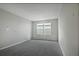 Spacious bedroom with grey carpet and windows at 180 Flag Lilly Ln, Umatilla, FL 32784