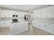 Modern kitchen featuring white cabinets, stainless steel appliances, and a large island at 180 Flag Lilly Ln, Umatilla, FL 32784