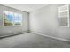 Bright bedroom featuring grey carpet and a window at 180 Flag Lilly Ln, Umatilla, FL 32784