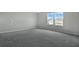 Spacious bedroom with grey carpet and windows at 180 Flag Lilly Ln, Umatilla, FL 32784