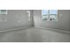 Spacious bedroom with grey carpet and large windows at 180 Flag Lilly Ln, Umatilla, FL 32784