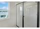 Shower with glass enclosure and window at 180 Flag Lilly Ln, Umatilla, FL 32784