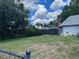 Large backyard with a screened-in pool and grassy area at 2086 Camelot Blvd, St Cloud, FL 34772
