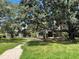 Two-story house with a large front yard and mature trees at 2086 Camelot Blvd, St Cloud, FL 34772