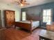 Main bedroom with wood flooring and a large bed at 2086 Camelot Blvd, St Cloud, FL 34772