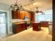 Kitchen with island, dark wood cabinets, and tile floors at 2086 Camelot Blvd, St Cloud, FL 34772