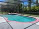 Inviting kidney-shaped pool with a built-in bench at 2086 Camelot Blvd, St Cloud, FL 34772