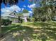 House exterior showcasing landscaping and walkway at 2086 Camelot Blvd, St Cloud, FL 34772