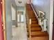 Staircase with wood railing and chair lift at 2086 Camelot Blvd, St Cloud, FL 34772