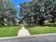 House exterior showcasing a home with a spacious lawn and walkway at 2086 Camelot Blvd, St Cloud, FL 34772