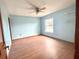 Light and airy bedroom with ceiling fan and laminate floors at 2086 Camelot Blvd, St Cloud, FL 34772