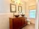 Bathroom with double vanity, large mirror, and updated fixtures at 2086 Camelot Blvd, St Cloud, FL 34772