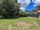 Large backyard with mature trees and grassy areas at 2086 Camelot Blvd, St Cloud, FL 34772