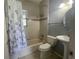 Clean bathroom featuring a shower/tub combo, toilet and vanity at 2086 Camelot Blvd, St Cloud, FL 34772