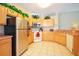 Kitchen with light wood cabinets, stainless steel appliances, and ample counter space at 648 Copeland Dr, Haines City, FL 33844