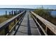 Wooden dock extending over calm waters, providing a serene waterfront view at 648 Copeland Dr, Haines City, FL 33844