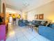 Open living room with kitchen views, tile floors, and neutral decor at 648 Copeland Dr, Haines City, FL 33844