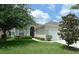 Single-story home with a two car garage and lush landscaping at 648 Copeland Dr, Haines City, FL 33844