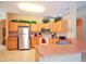 Kitchen features light wood cabinets, stainless steel appliances, and a corner sink at 648 Copeland Dr, Haines City, FL 33844