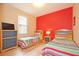 Bedroom with two twin beds and colorful bedding at 648 Copeland Dr, Haines City, FL 33844