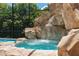 Private spa nestled into rock waterfall feature at 5222 Waterside Vista Ln, St Cloud, FL 34771