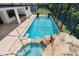 Enclosed pool and spa with fire bowls and waterfall feature at 5222 Waterside Vista Ln, St Cloud, FL 34771